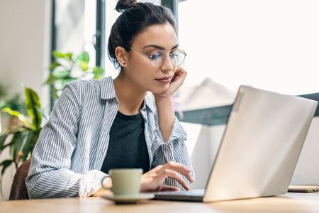 Woman using a laptop in her office